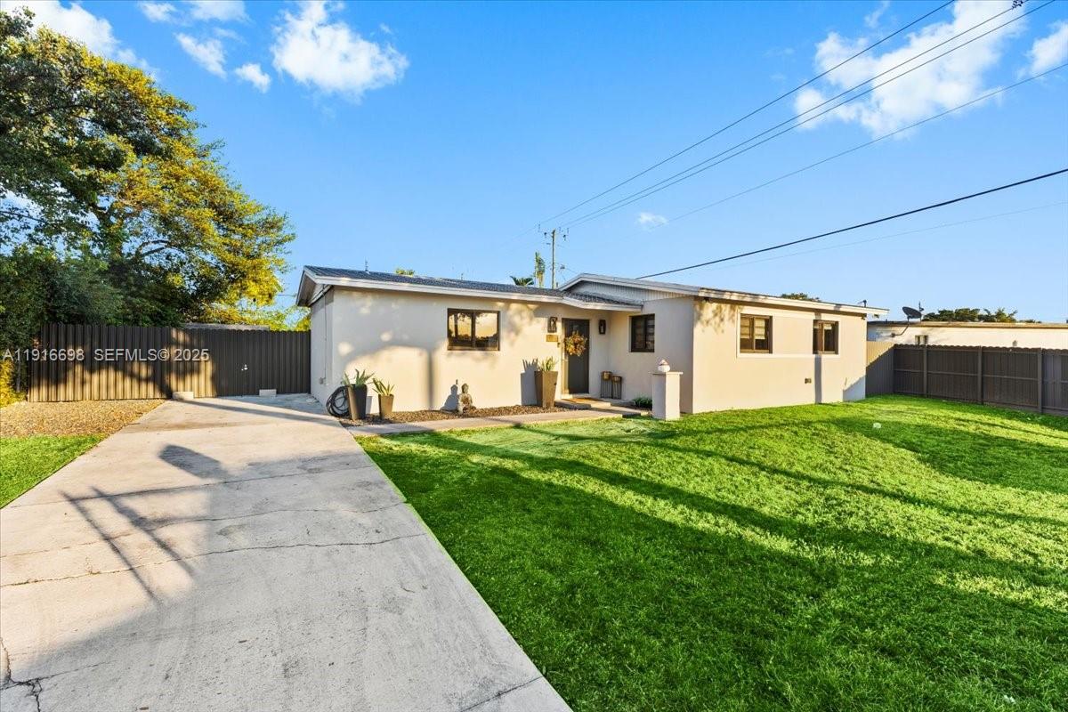 17121 Northwest 82nd Avenue Hialeah, FL 33015 - Photo 3 of 29 a front view of house with yard and green space