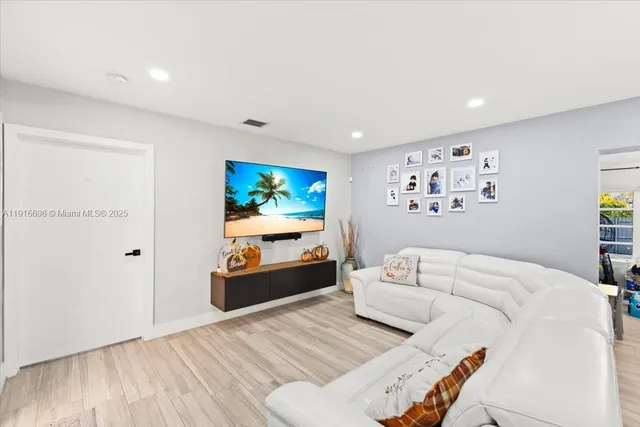 a bedroom with furniture and a flat screen tv