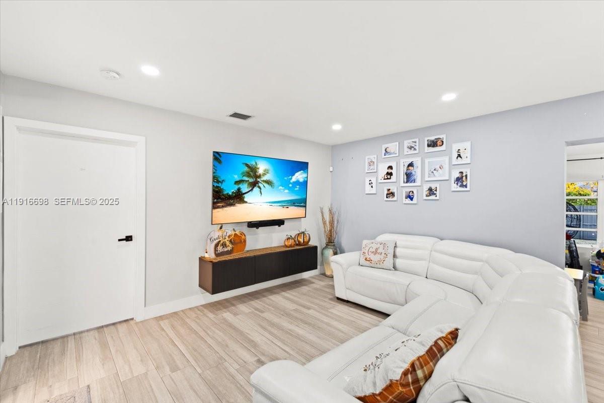 17121 Northwest 82nd Avenue Hialeah, FL 33015 - Photo 5 of 29 a bedroom with furniture and a flat screen tv