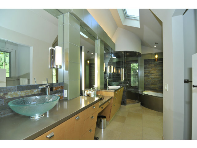 875 Riverside Drive Los Altos, CA 94024 - Photo 14 of 23 a bathroom with a granite countertop sink a large mirror and a bathtub