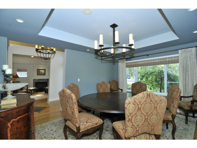875 Riverside Drive Los Altos, CA 94024 - Photo 4 of 23 a view of a dining room with furniture a chandelier and large windows