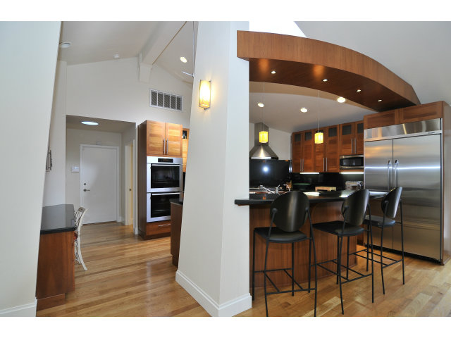 875 Riverside Drive Los Altos, CA 94024 - Photo 8 of 23 a kitchen with stainless steel appliances kitchen island granite countertop a refrigerator and cabinets