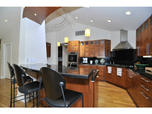 875 Riverside Drive Los Altos, CA 94024 - Photo 9 of 23 a kitchen with stainless steel appliances granite countertop a sink a stove a dining table and chairs