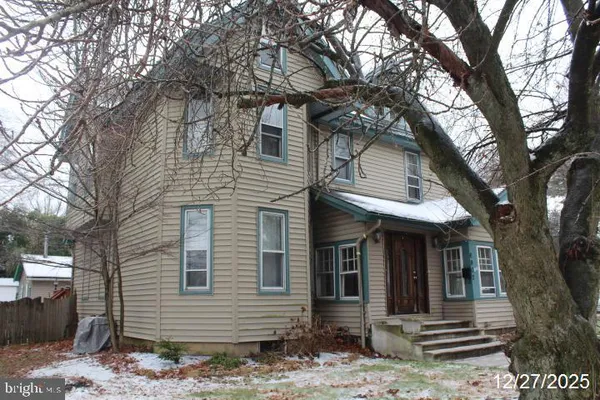 a front view of a house with trees