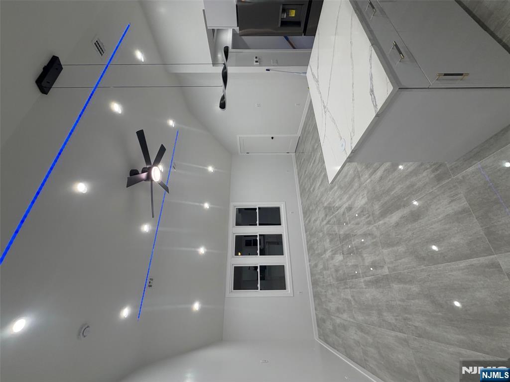 40 Elder Avenue, Unit 2 Bergenfield, NJ 07621 - Photo 2 of 9 a large kitchen with kitchen island a island wooden floor and a ceiling fan