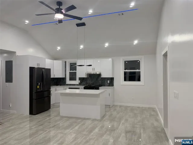 a kitchen with stainless steel appliances a refrigerator and a stove top oven