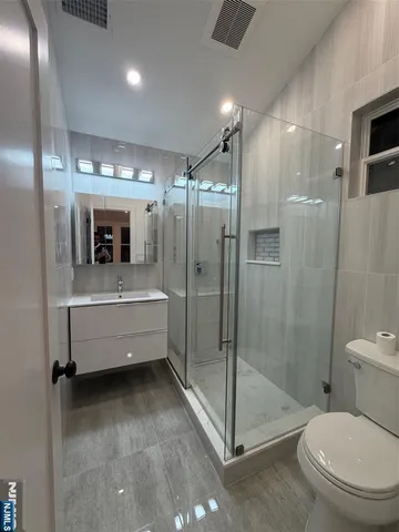 a bathroom with a toilet sink and shower
