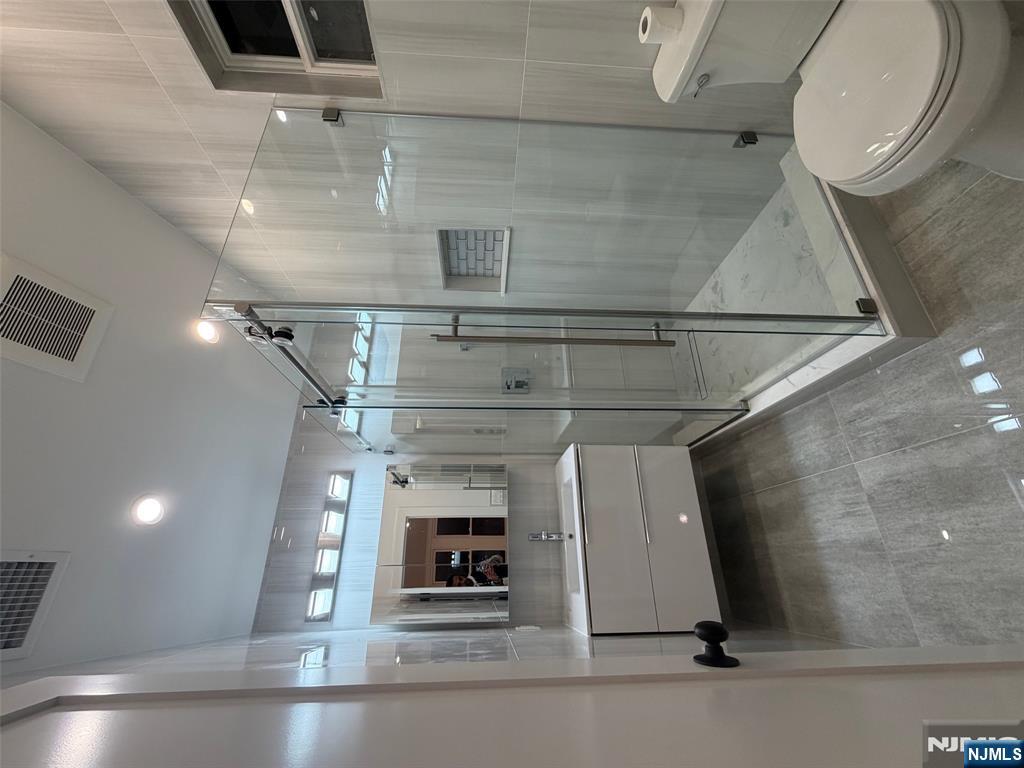 40 Elder Avenue, Unit 2 Bergenfield, NJ 07621 - Photo 5 of 9 a bathroom with a toilet sink and shower