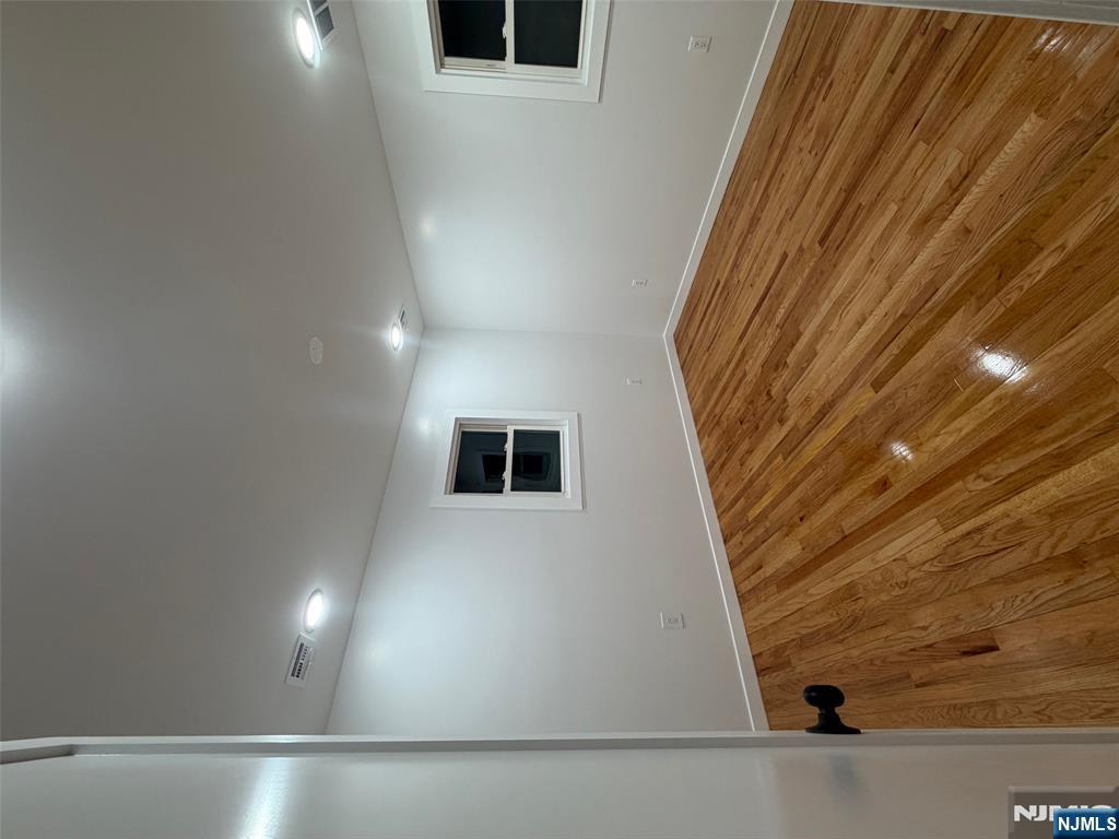 40 Elder Avenue, Unit 2 Bergenfield, NJ 07621 - Photo 7 of 9 a view of an empty room with wooden floor and a window