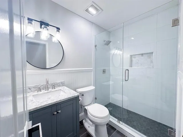 a bathroom with a sink toilet and shower