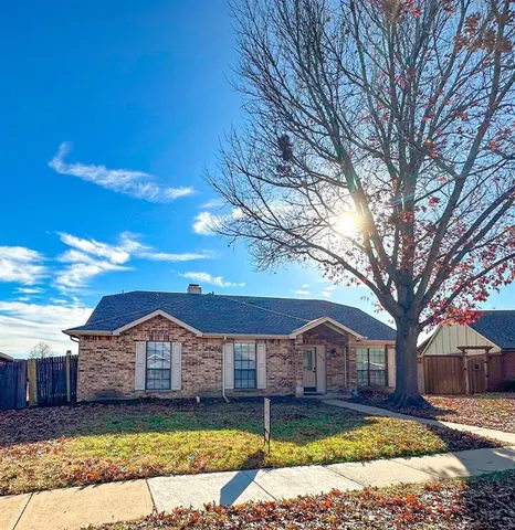 a front view of a house with a yard bathtub and trees