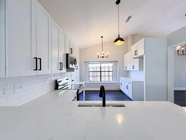 a view of a livingroom with furniture and windows