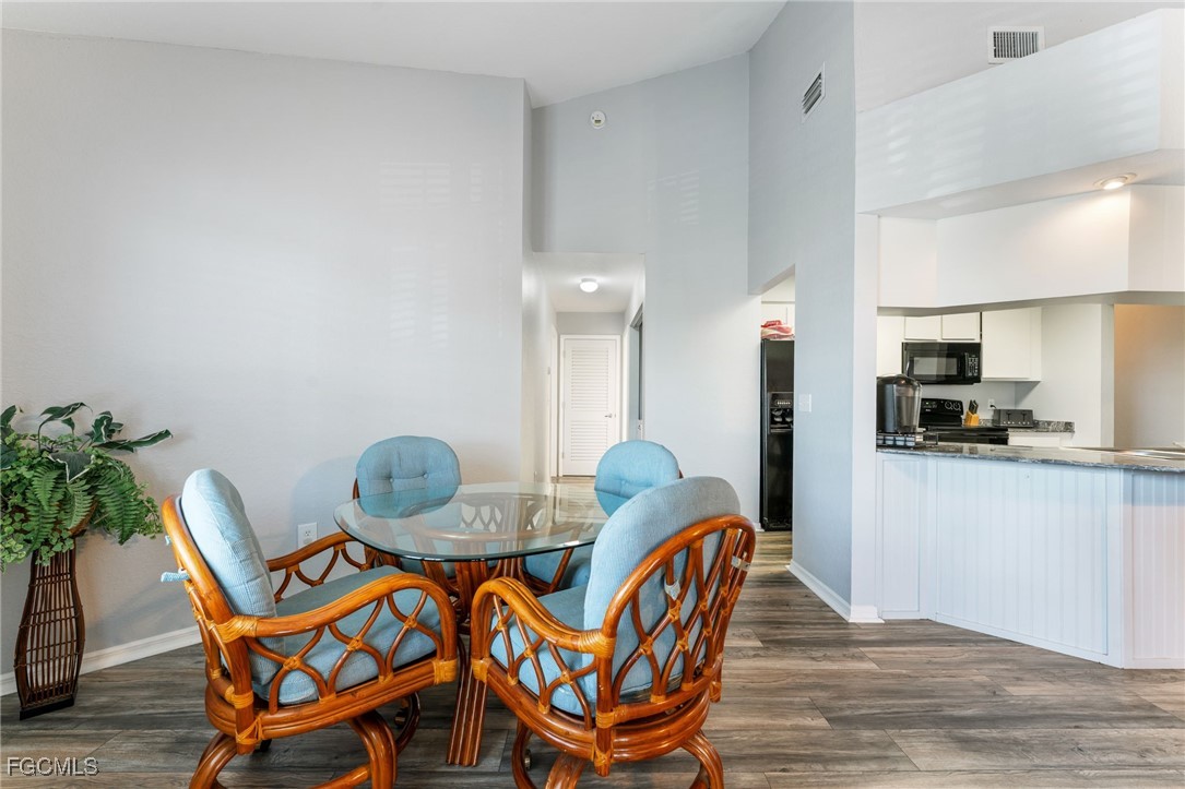 950 Moody Road, Unit 124 North Fort Myers, FL 33903 - Photo 15 of 44 a dining room with furniture and wooden floor