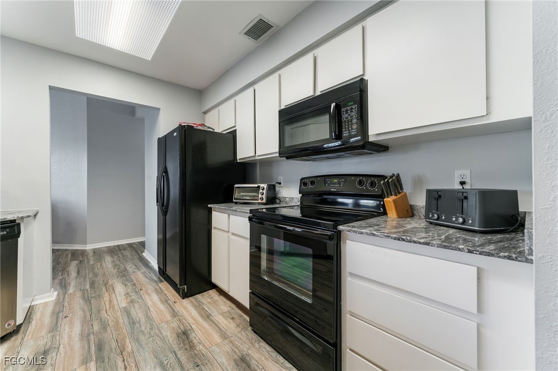 950 Moody Road, Unit 124 North Fort Myers, FL 33903 - Photo 16 of 44 a kitchen with stainless steel appliances granite countertop a refrigerator stove and microwave