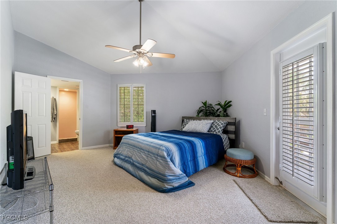 950 Moody Road, Unit 124 North Fort Myers, FL 33903 - Photo 20 of 44 a spacious bedroom with a bed and a chandelier