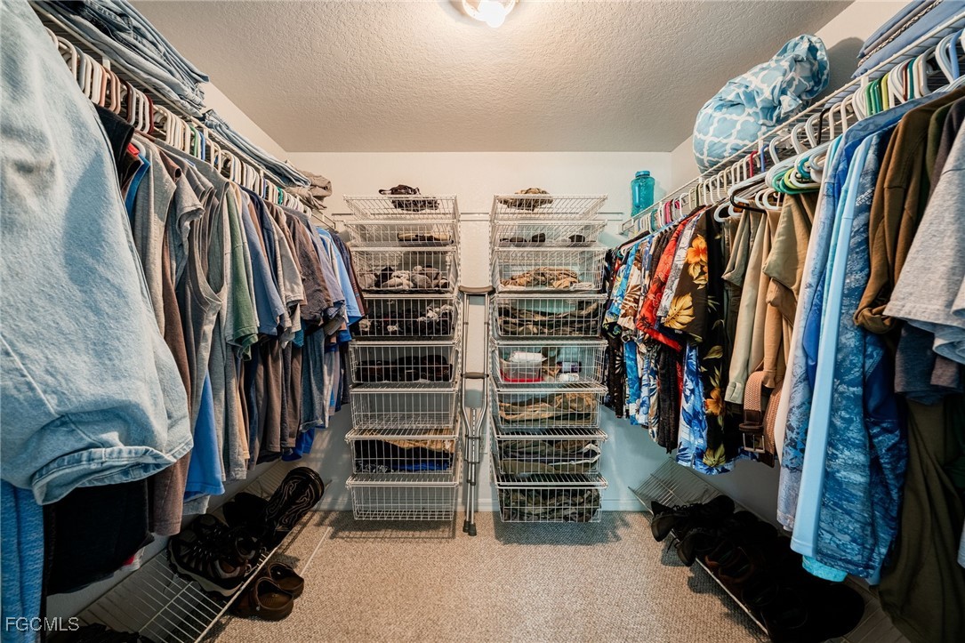 950 Moody Road, Unit 124 North Fort Myers, FL 33903 - Photo 24 of 44 a view of walk in closet with clothes and shoes