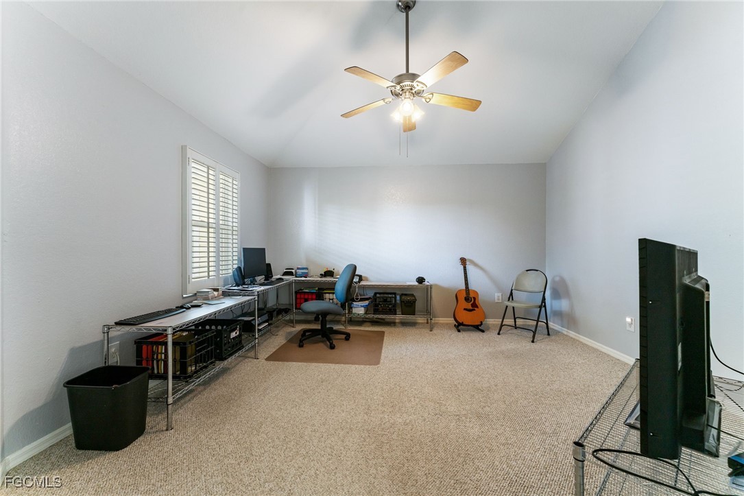 950 Moody Road, Unit 124 North Fort Myers, FL 33903 - Photo 29 of 44 a living room with furniture gym equipment and a flat screen tv
