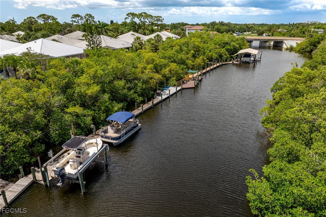 950 Moody Road, Unit 124 North Fort Myers, FL 33903 - Photo 3 of 44 a view of a lake with lawn chairs