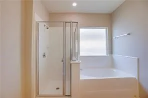 a bathroom with a glass shower door
