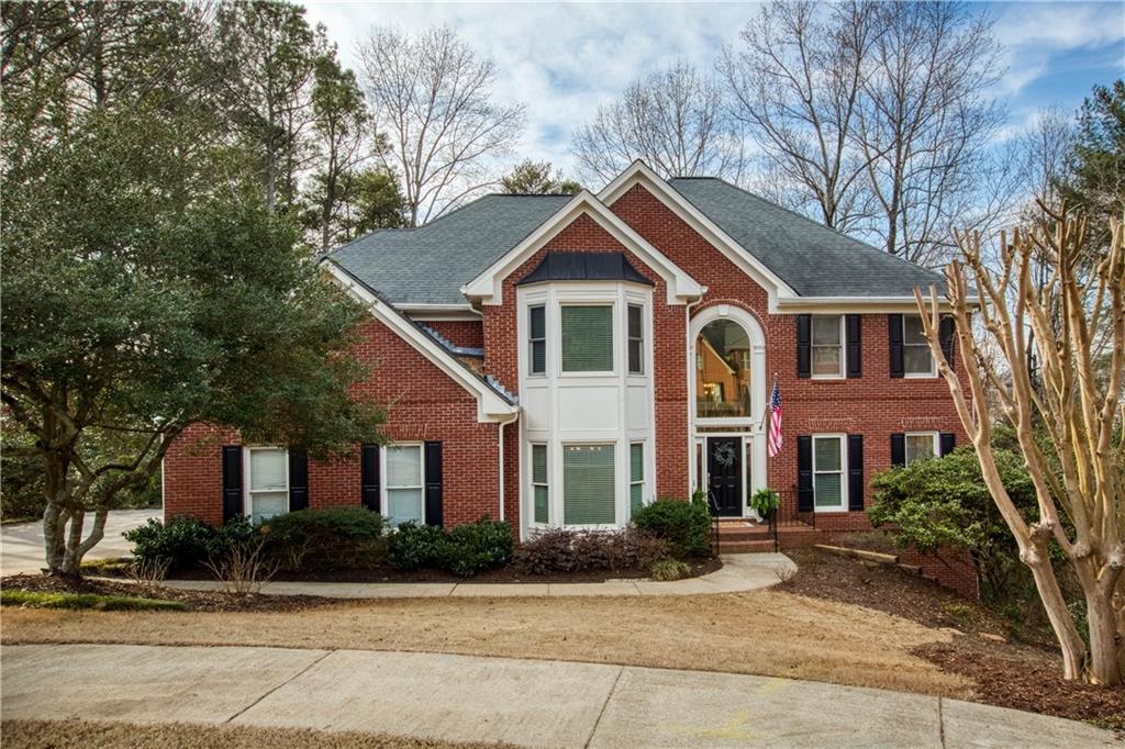 620 Brookline Ridge Alpharetta, GA 30022 - Photo 1 of 1 a front view of a house with yard and trees