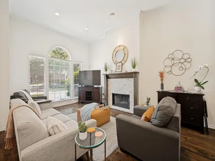 a living room with furniture a fireplace and a large window