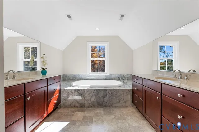 a spacious bathroom with a large tub sink and vanity