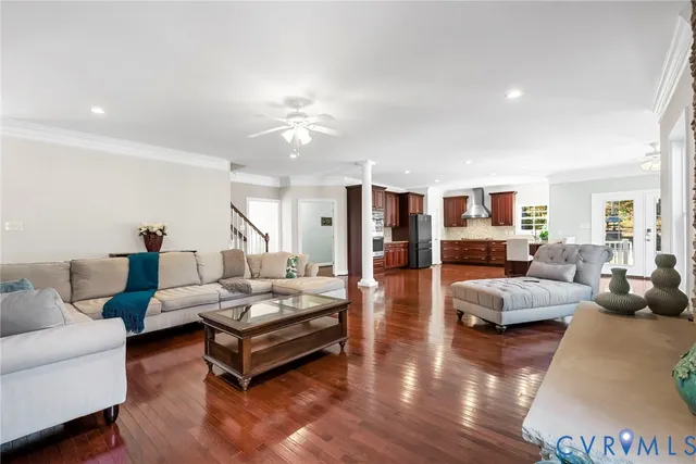 a living room with furniture and wooden floor