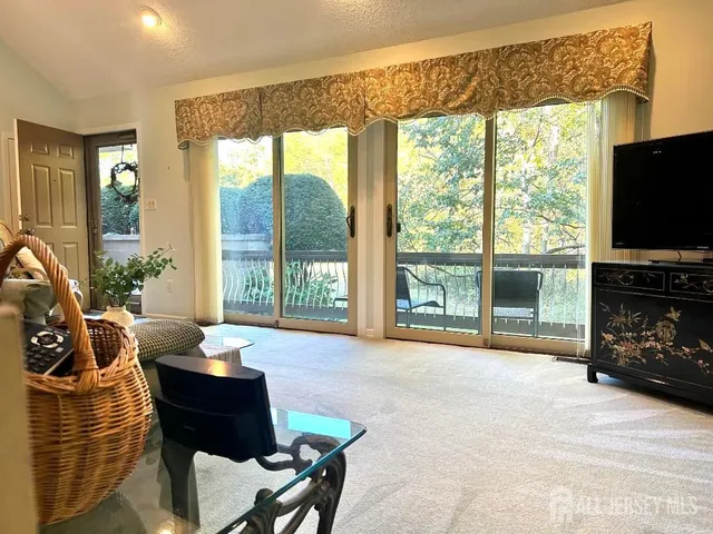 a living room with fireplace furniture and a flat screen tv