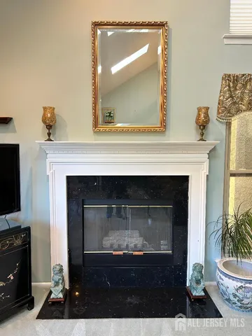 a kitchen with stainless steel appliances granite countertop a stove top oven a sink dishwasher a dining table and chairs with wooden cabinets