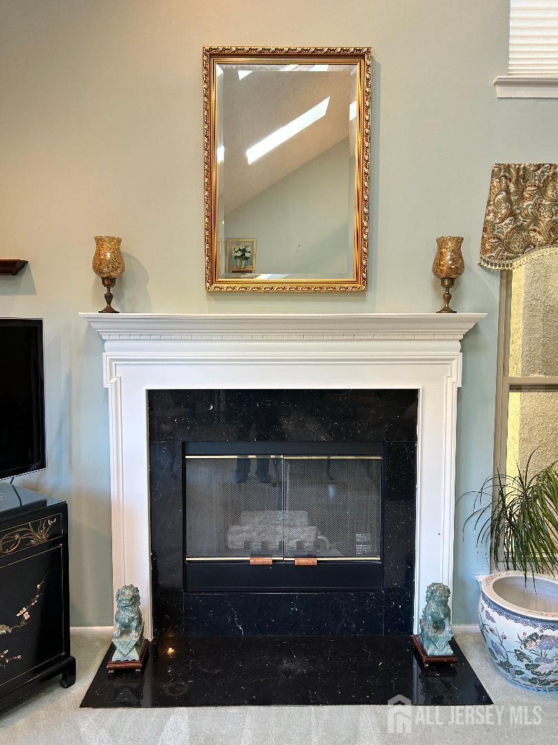 75 Kelly Drive Edison, NJ 08820 - Photo 14 of 41 a living room with a fireplace and a flat screen tv