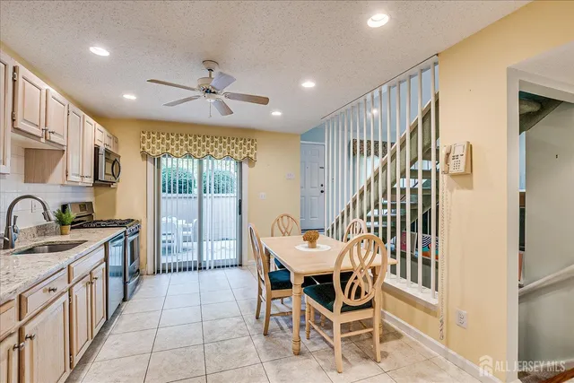 a bathroom with a granite countertop toilet sink and mirror