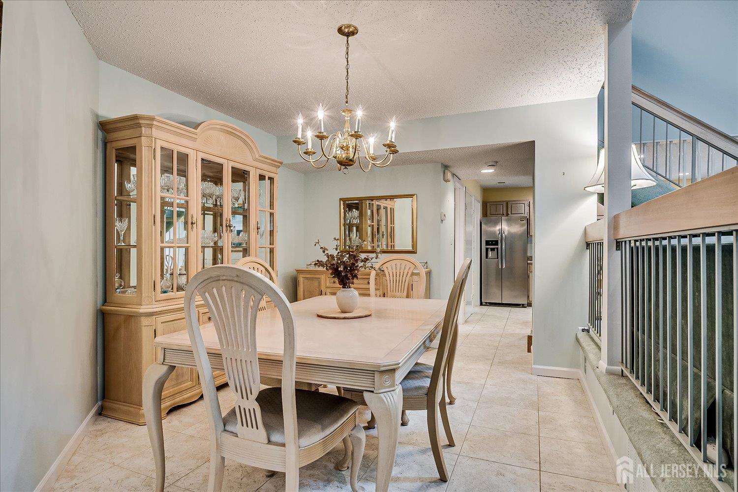 75 Kelly Drive Edison, NJ 08820 - Photo 19 of 41 a view of a dining room with furniture and chandelier