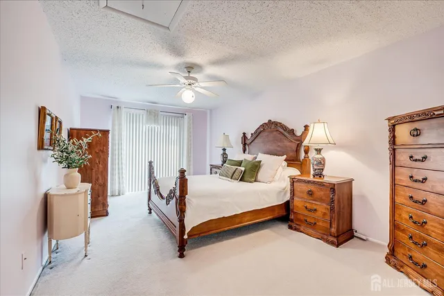 a bathroom with a bathtub shower sink vanity mirror and toilet