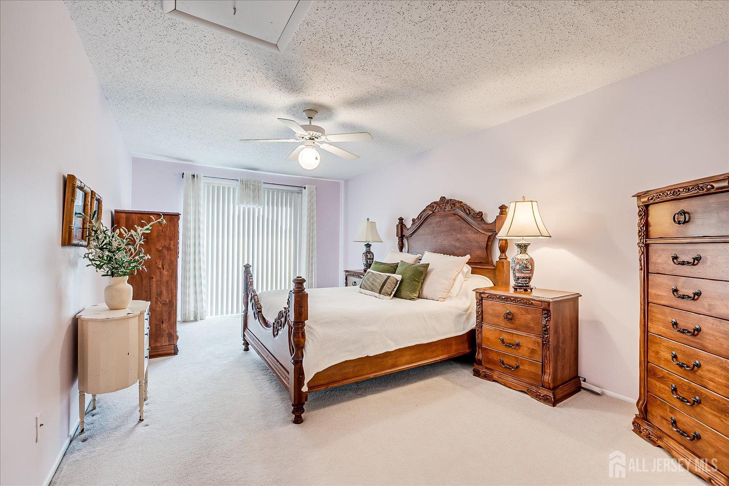 75 Kelly Drive Edison, NJ 08820 - Photo 21 of 41 a bedroom with a bed and a chandelier