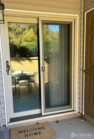 a backyard of a house with table and chairs