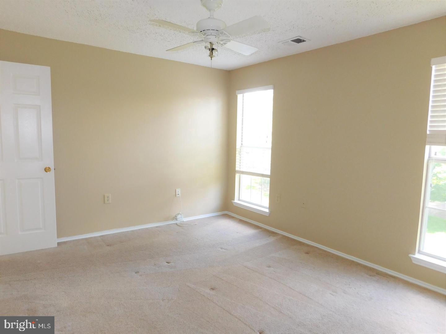 20958 Timber Ridge Terrace, Unit 203 Ashburn, VA 20147 - Photo 12 of 18 LARGE AND BRIGHT MASTER BEDROOM WITH CEILING FAN