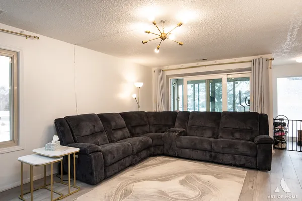 a living room with furniture a couch and a chandelier