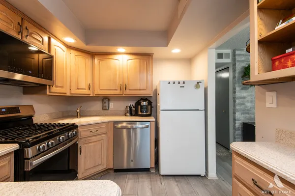a kitchen with a refrigerator stove and microwave