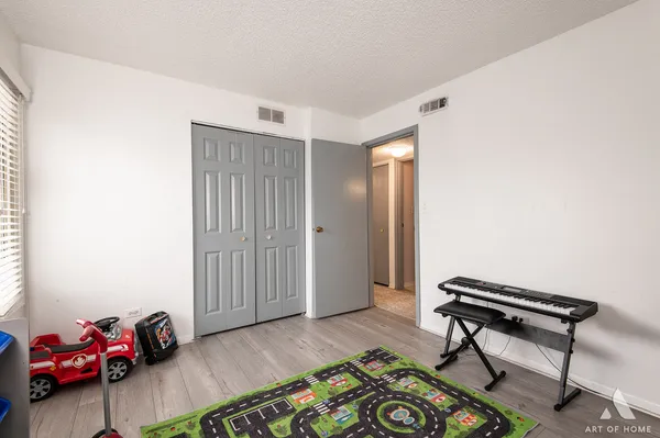 a bedroom with furniture and a wooden floor