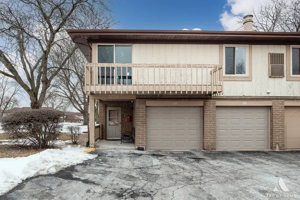 a view of a house with a yard and garage