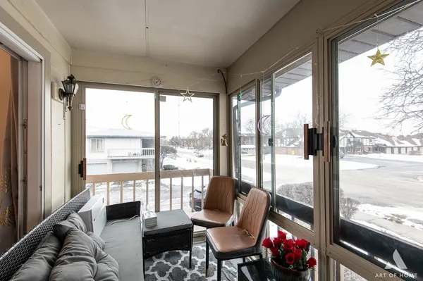 a living room with furniture and floor to ceiling windows