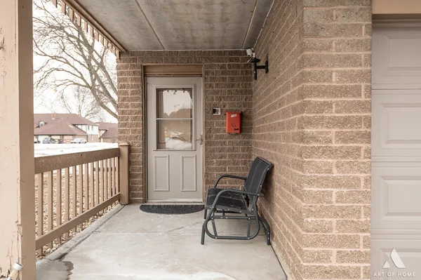 a view of a door with a chair and a door