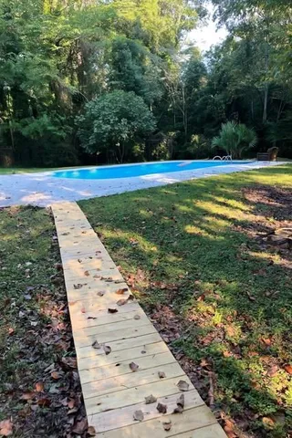 a view of a swimming pool with a yard