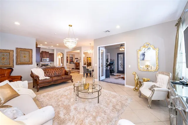 a living room with furniture and a chandelier