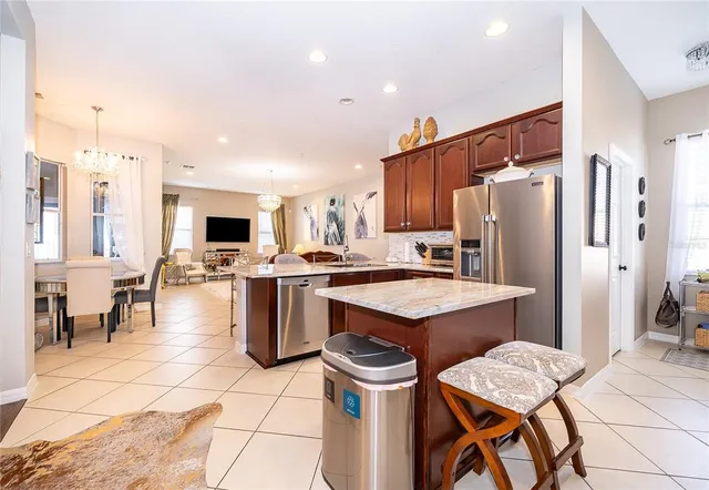 a kitchen with a sink a kitchen island and stainless steel appliances