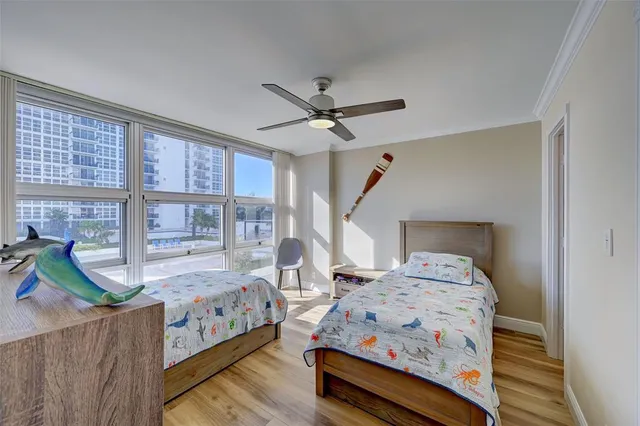 a bedroom with bed and wooden floor
