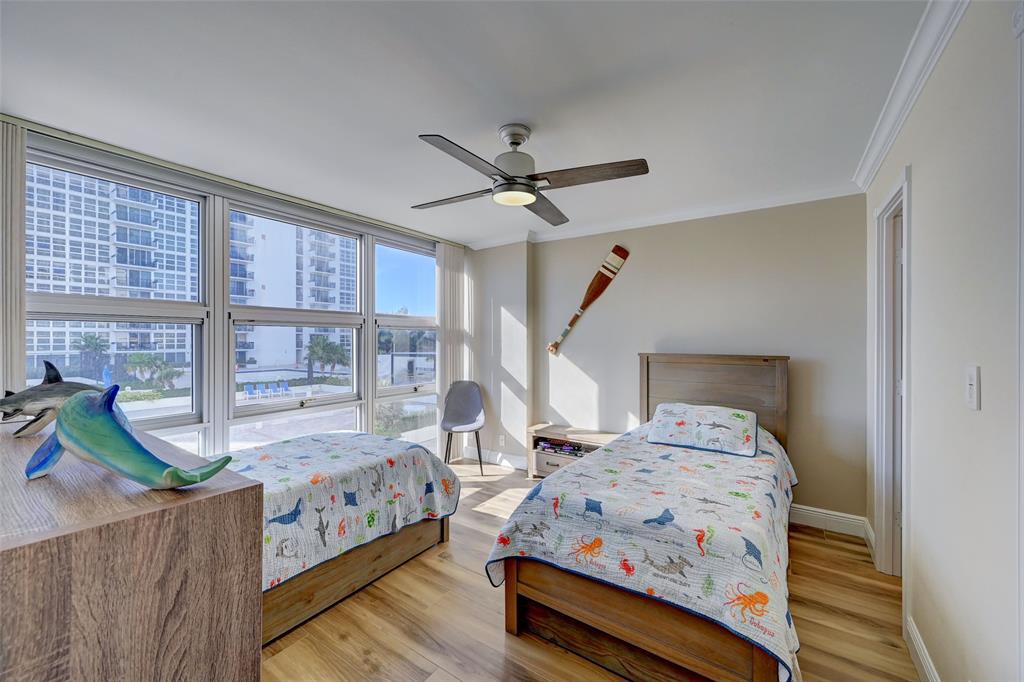 531 North Ocean Boulevard, Unit 506 Pompano Beach, FL 33062 - Photo 13 of 47 a bedroom with bed and wooden floor