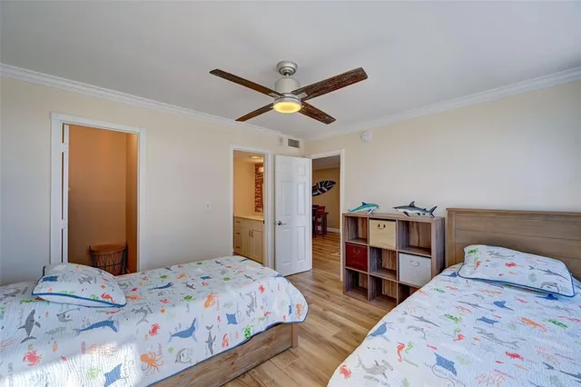 a bedroom with bed and wooden floor