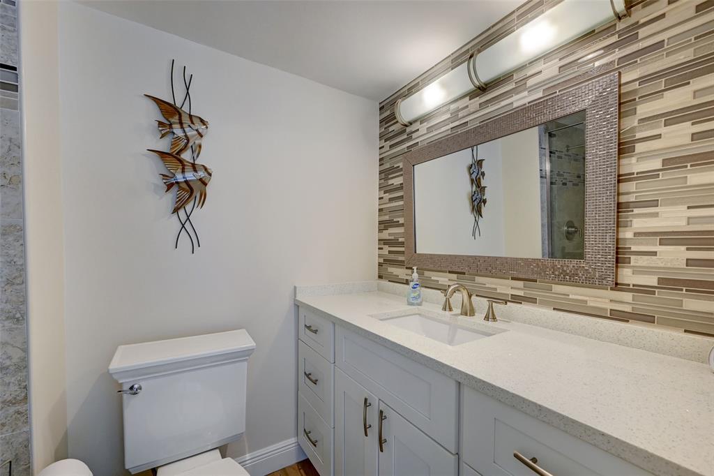 531 North Ocean Boulevard, Unit 506 Pompano Beach, FL 33062 - Photo 19 of 47 a bathroom with a sink a toilet and mirror