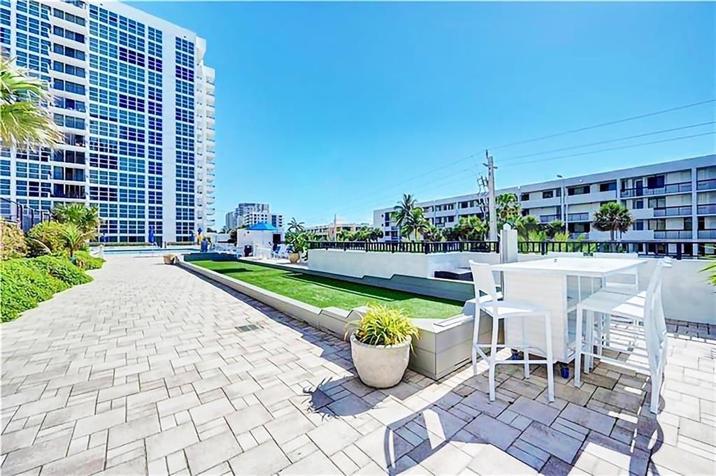 531 North Ocean Boulevard, Unit 506 Pompano Beach, FL 33062 - Photo 24 of 47 a view of a patio with chairs and a table and chair